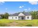 Rear of home features a covered patio and view of the wooded backyard area at 7103 Louisville Rd., Aynor, SC 29511