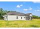 A view of the back of the home showcasing the screened in porch and level yard at 7103 Louisville Rd., Aynor, SC 29511