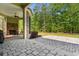 Covered patio with a stone fireplace, and a beautifully landscaped backyard at 8008 Mcsweeney Ct., Myrtle Beach, SC 29588