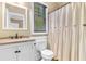Clean bathroom showing a vanity, mirror, toilet, and shower with curtain at 8008 Mcsweeney Ct., Myrtle Beach, SC 29588