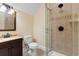 Well-lit bathroom featuring a glass shower, a decorative light fixture, and tile flooring at 8008 Mcsweeney Ct., Myrtle Beach, SC 29588