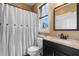 Cozy bathroom featuring a shower with a white curtain, a window and a granite countertop sink at 8008 Mcsweeney Ct., Myrtle Beach, SC 29588