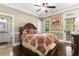Comfortable bedroom with hardwood floors, a queen sized bed, and an adjacent bathroom at 8008 Mcsweeney Ct., Myrtle Beach, SC 29588