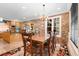 Elegant dining room with stone walls, a chandelier, and views of the kitchen, ideal for Gathering gatherings at 8008 Mcsweeney Ct., Myrtle Beach, SC 29588
