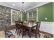 Inviting dining room featuring a rustic table, chandelier, stone accent wall, and large window at 8008 Mcsweeney Ct., Myrtle Beach, SC 29588