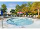 Community kiddie pool with mushroom fountain surrounded by lounge chairs and umbrellas at 8008 Mcsweeney Ct., Myrtle Beach, SC 29588