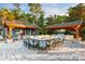 Stylish outdoor dining area with built-in grills, covered seating, and stone pavers at 8008 Mcsweeney Ct., Myrtle Beach, SC 29588