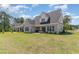 Expansive backyard showcasing a well-manicured lawn, patio with furniture, and pristine brick exterior at 801 Celene Ct., Myrtle Beach, SC 29579