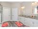 Bright bathroom with double sinks, white cabinets, granite counters, and clean white doors at 801 Celene Ct., Myrtle Beach, SC 29579