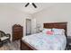 Cozy bedroom with hardwood floors, ceiling fan, decorative furnishings, and a comfortable queen-sized bed at 801 Celene Ct., Myrtle Beach, SC 29579