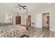 Bedroom featuring two beds, wooden furniture, ceiling fan, natural light, and bathroom access at 801 Celene Ct., Myrtle Beach, SC 29579
