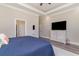 Spacious bedroom featuring a large window, tray ceiling, TV, and wooden furniture at 801 Celene Ct., Myrtle Beach, SC 29579