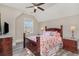 Comfortable bedroom with hardwood floors, ceiling fan, and large window providing ample natural light at 801 Celene Ct., Myrtle Beach, SC 29579