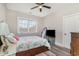Well-lit bedroom with large window, ceiling fan, hardwood floors, television, and queen sized bed at 801 Celene Ct., Myrtle Beach, SC 29579
