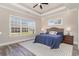 Comfortable bedroom with a tray ceiling, ceiling fan, and a large window overlooking the backyard at 801 Celene Ct., Myrtle Beach, SC 29579