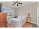 Bright bedroom with hardwood floors, a ceiling fan, and large window providing ample light at 801 Celene Ct., Myrtle Beach, SC 29579