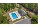 Aerial view of community pool with lounge chairs and covered seating area amidst lush greenery at 801 Celene Ct., Myrtle Beach, SC 29579