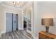 Elegant entryway featuring wood floors, paneled glass door, and stylish decor with a modern touch at 801 Celene Ct., Myrtle Beach, SC 29579