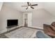 Cozy living room features hardwood floors, ceiling fan, comfortable seating, and television at 801 Celene Ct., Myrtle Beach, SC 29579