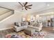 Open-concept living room featuring a large sectional sofa, stairs, and seamless flow to kitchen at 801 Celene Ct., Myrtle Beach, SC 29579