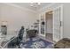 Bright home office with a glass desk, comfortable chair, and view through the glass paneled doors at 801 Celene Ct., Myrtle Beach, SC 29579