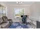 Cozy home office with a glass desk, comfortable chair, and a recliner with ample light at 801 Celene Ct., Myrtle Beach, SC 29579