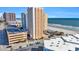 High-rise condo complex featuring a pool, sandy beach, and beautiful ocean views at 9550 Shore Dr. # 633, Myrtle Beach, SC 29572