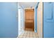 View of a condo entrance highlighting the wood door and blue walls at 9550 Shore Dr. # 633, Myrtle Beach, SC 29572
