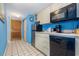 A compact kitchen with stainless steel appliances and white cabinetry at 9550 Shore Dr. # 633, Myrtle Beach, SC 29572