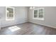 Bright dining room with luxury vinyl flooring and two windows with backyard views at 108 Old Chimney Ln, Conway, SC 29526