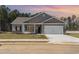 Charming single-story home with gray siding, stone accents, and a spacious two-car garage at 108 Old Chimney Ln, Conway, SC 29526