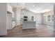 Bright kitchen with stainless steel appliances, island, white cabinets, and luxury vinyl flooring at 108 Old Chimney Ln, Conway, SC 29526