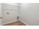 An empty laundry room with wood-look floors and wire shelving at 108 Old Chimney Ln, Conway, SC 29526