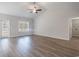 Bright living room with luxury vinyl flooring, ceiling fan and backyard view at 108 Old Chimney Ln, Conway, SC 29526