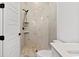 Elegant bathroom showcasing a modern shower with marble tiling, matte fixtures and pebble flooring at 1219 Bentcreek Ln., Myrtle Beach, SC 29579