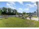 A well kept backyard features a brick fire pit, an outdoor seating area, and well manicured green grass at 1313 Cascarilla Ct., Myrtle Beach, SC 29579