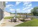 Well maintained backyard features a brick fire pit, outdoor seating area, green grass and a white picket fence at 1313 Cascarilla Ct., Myrtle Beach, SC 29579