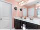 Bright bathroom featuring a double vanity, large mirror, and elegant fixtures at 1313 Cascarilla Ct., Myrtle Beach, SC 29579