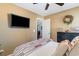 Inviting bedroom with comfortable bedding, a wall-mounted TV, and ample natural light at 1313 Cascarilla Ct., Myrtle Beach, SC 29579