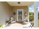 Charming front porch with seating, decorative accents, and a welcoming entrance to the home at 1313 Cascarilla Ct., Myrtle Beach, SC 29579