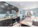 Modern kitchen with granite countertops, stainless steel appliances, and a view into the cozy dining area at 1313 Cascarilla Ct., Myrtle Beach, SC 29579