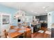 Bright, open-concept kitchen featuring dark cabinets, stainless appliances, and adjacent dining and living spaces at 1313 Cascarilla Ct., Myrtle Beach, SC 29579