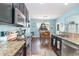 Eat-in kitchen featuring stainless steel appliances, granite countertops, and open view to the dining area at 1313 Cascarilla Ct., Myrtle Beach, SC 29579