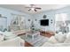 Cozy living room featuring stylish furniture, a modern TV setup, and lots of natural light at 1313 Cascarilla Ct., Myrtle Beach, SC 29579