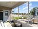 Relaxing screened porch with comfortable seating and views of the landscaped backyard with a fire pit at 1313 Cascarilla Ct., Myrtle Beach, SC 29579
