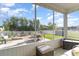 Relaxing screened porch with comfortable seating, outdoor dining set, and views of the landscaped backyard and fire pit at 1313 Cascarilla Ct., Myrtle Beach, SC 29579