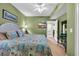 This bedroom has a ceiling fan, green walls, and access to other rooms at 1352 Villa Marbella Ct. # 1-204, Myrtle Beach, SC 29572