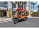 Close up view of an orange golf cart, ready to cruise around the neighborhood at 1352 Villa Marbella Ct. # 1-204, Myrtle Beach, SC 29572