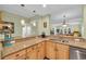 Kitchen featuring granite counters, wood cabinets and a view to the living room at 1352 Villa Marbella Ct. # 1-204, Myrtle Beach, SC 29572