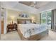 Bright main bedroom with a decorative tray ceiling, stylish lamps, and serene views from the large window at 1352 Villa Marbella Ct. # 1-204, Myrtle Beach, SC 29572